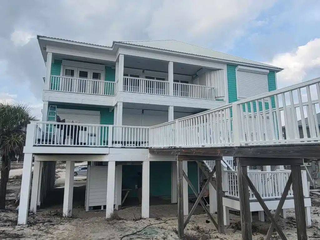 Beautiful Beach House Exterior Painting with Teal Siding and White Trim Two-story Gulf Coast beach house with a freshly coated exterior